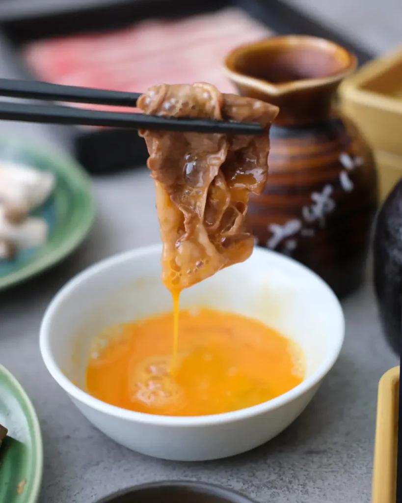 Wagyu dipped in egg yolk — the traditional way to eat sukiyaki